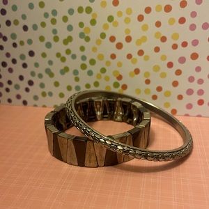 Two metal bracelets, one of them is stretchy, they are both silver,